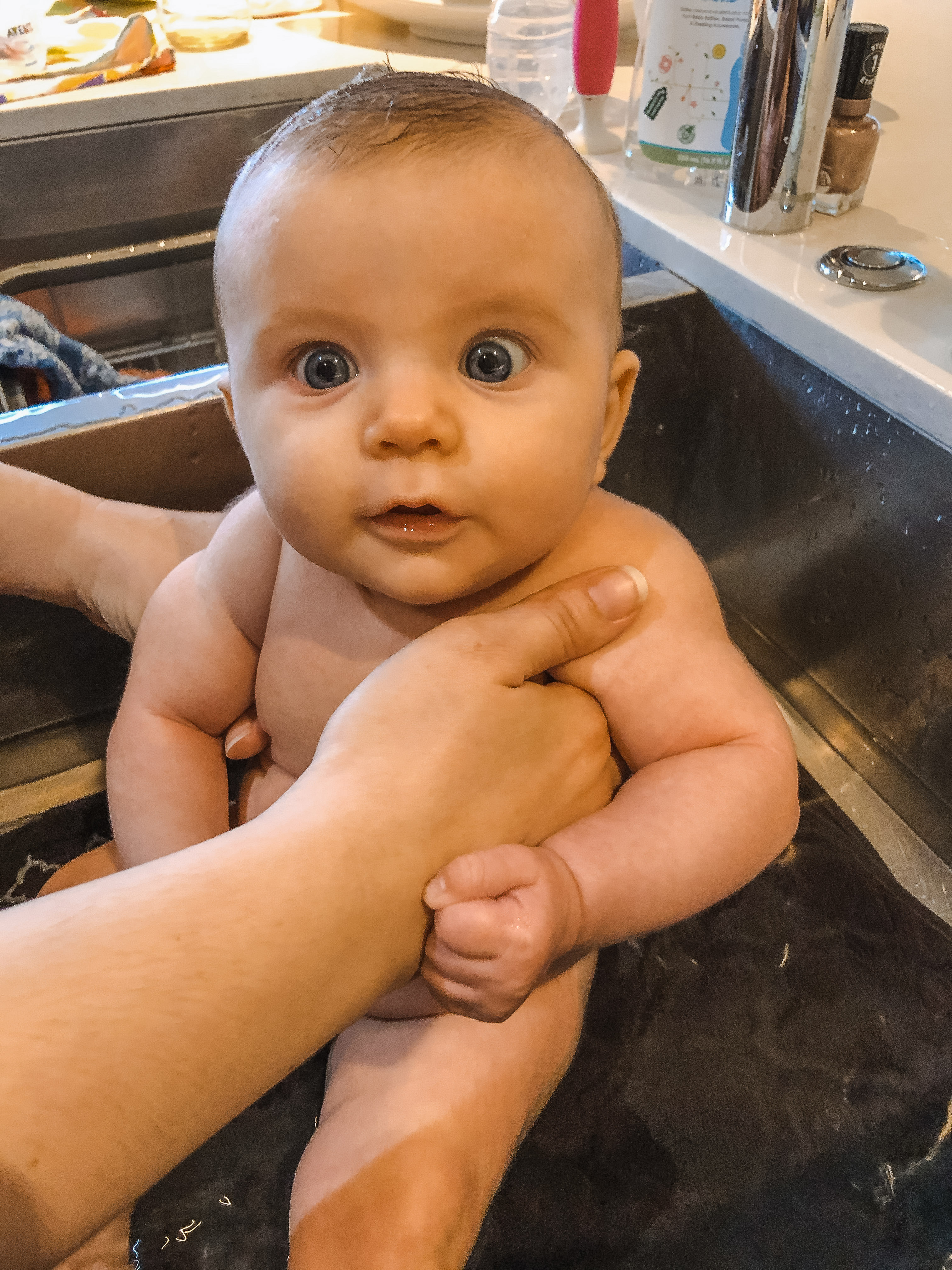 Baby having sink bath