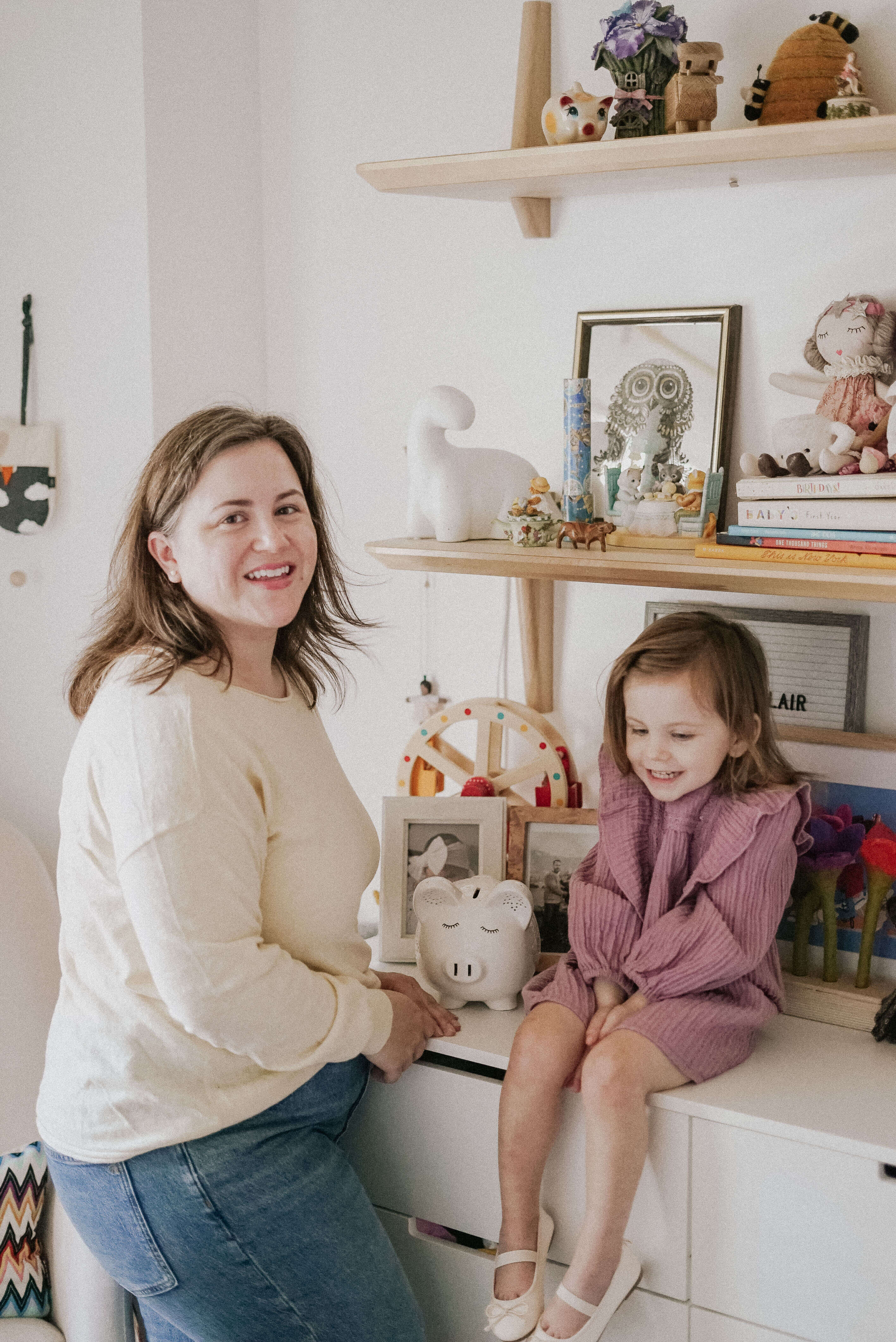 mom and toddler girl with piggy bank