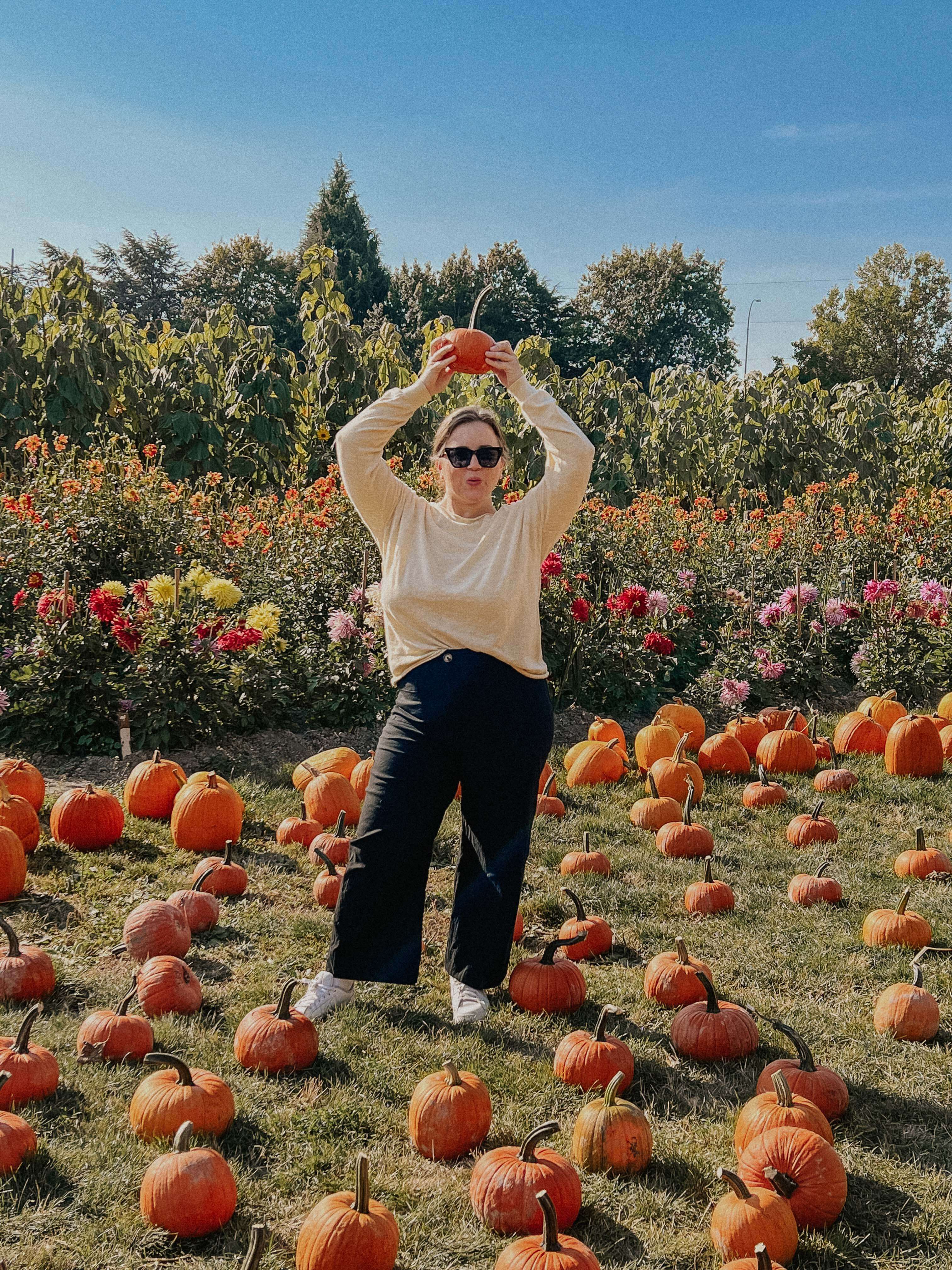 Woman holding pumpkin in pumpkin patch