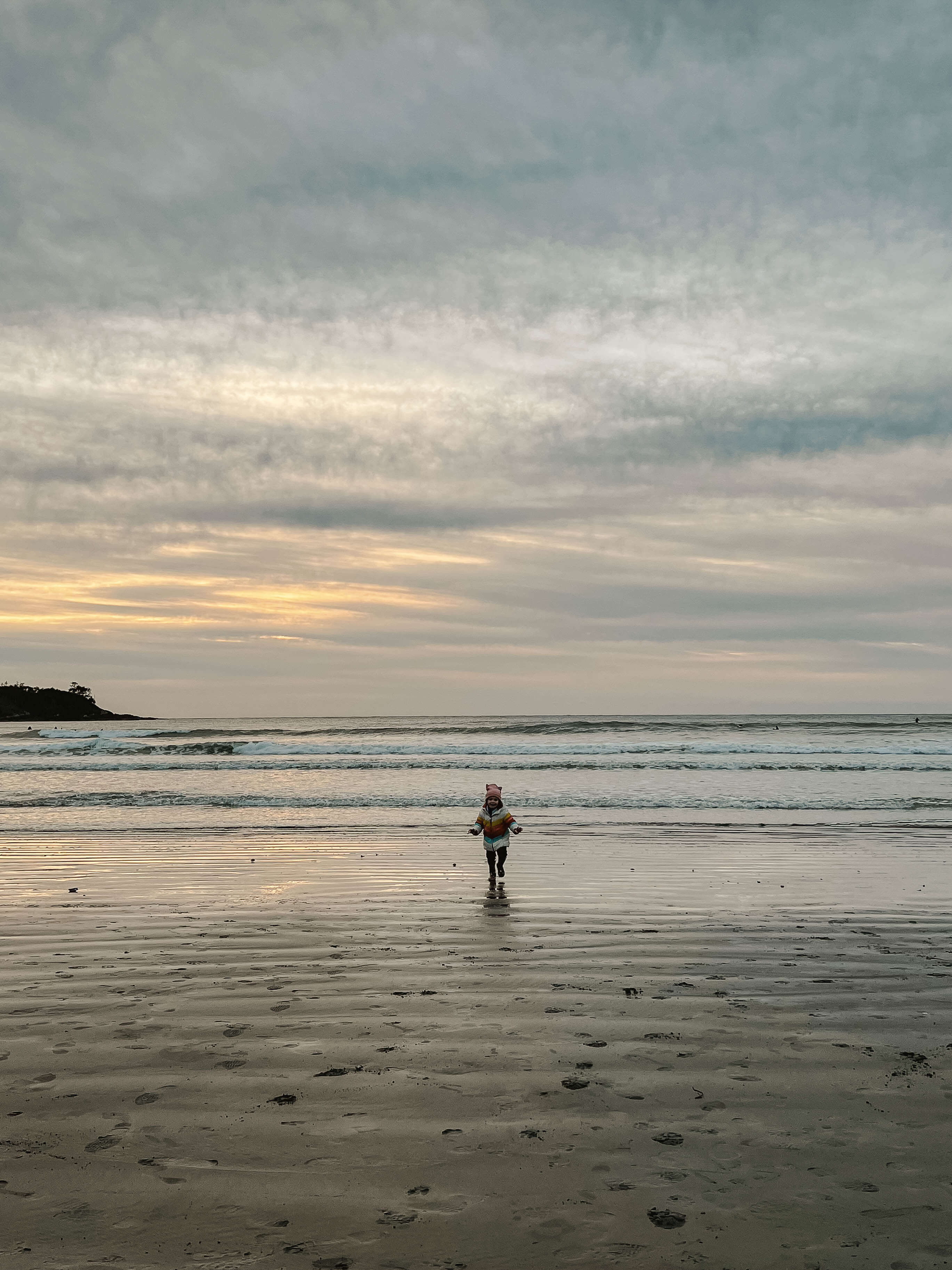 kid playing on beach in tofino, tofino with kids